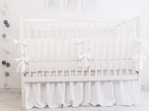 White linen crib bumper with short ties