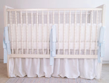 White linen crib bumper with blue  ties