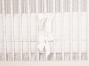 White linen crib bumper with short ties