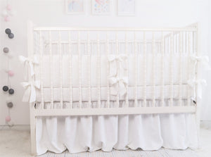 White linen crib bumper with blue  ties