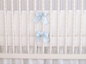 White linen crib bumper with blue  ties