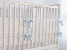 White linen crib bumper with blue  ties